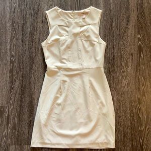 Cream colored shift dress with neckline cutout detail